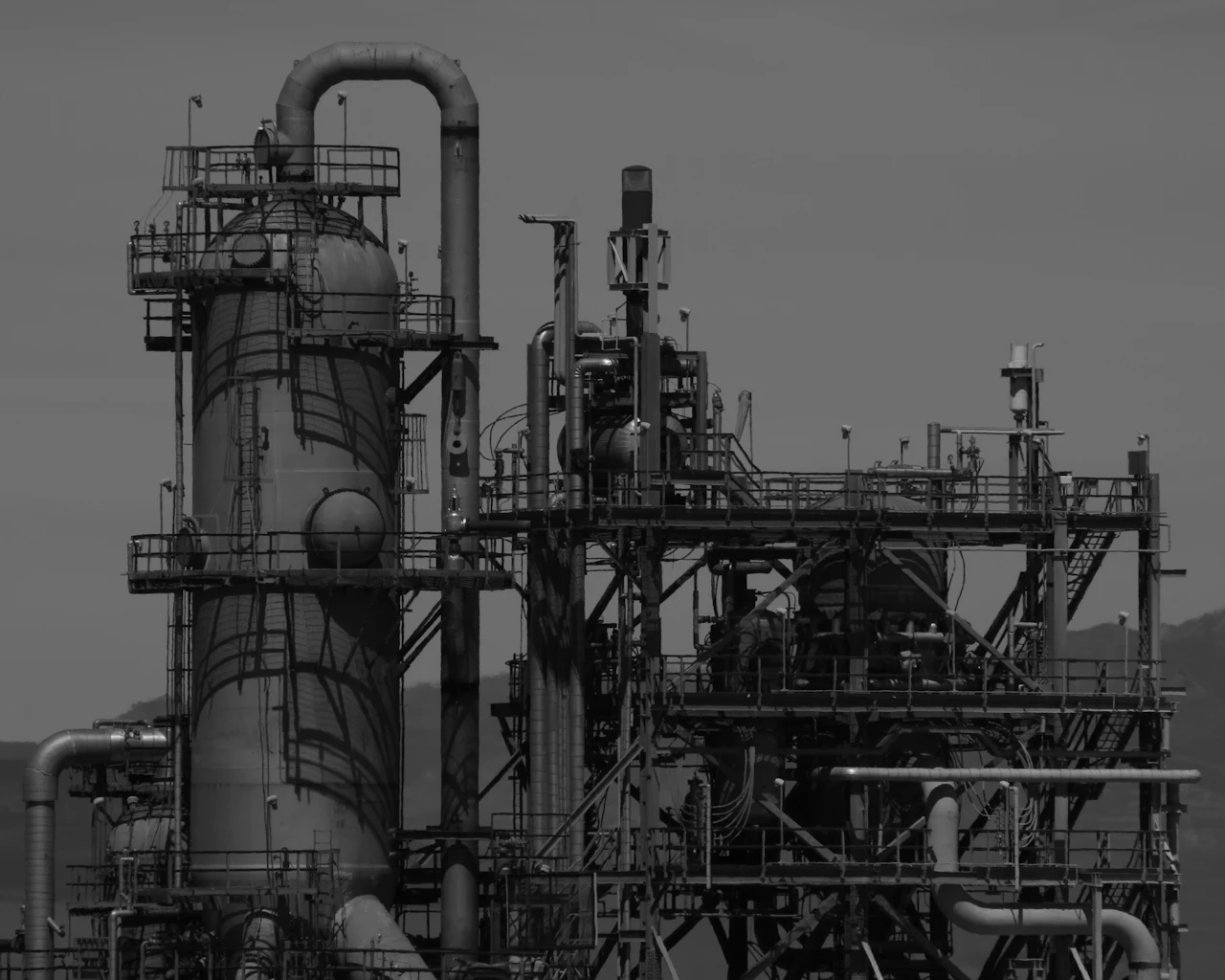 An industrial processing facility in black and white